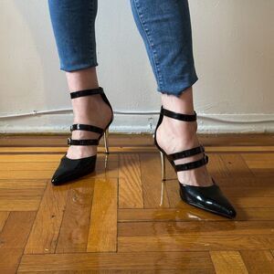 Street Feet buckle strap stilettos with metal heel and black patent upper